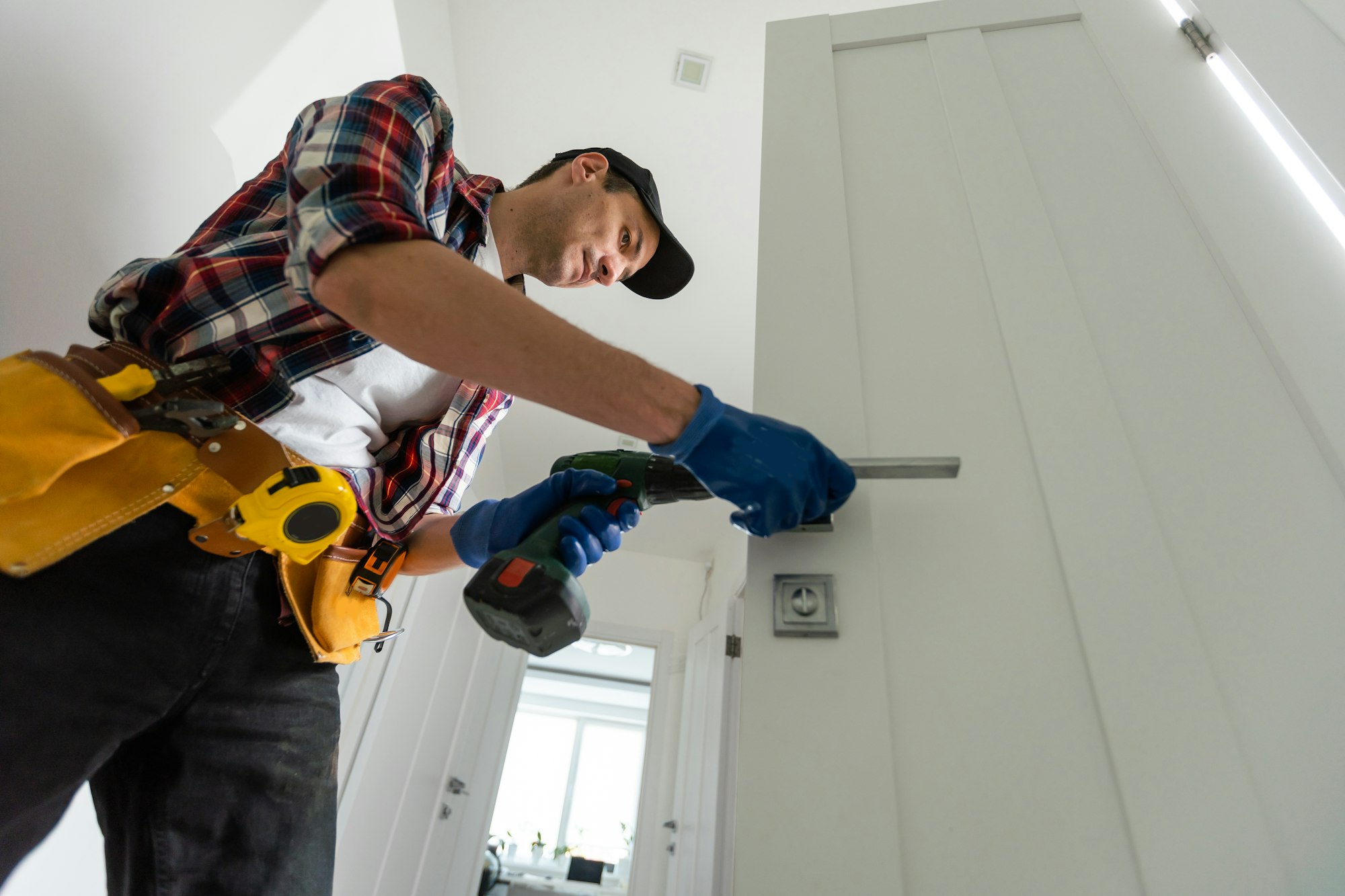 Young man fixing a door lock